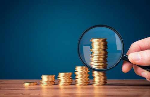Coins examined with magnifying glass