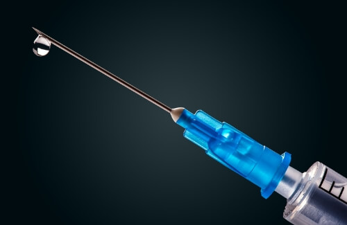 Close up of syringe with clear liquid