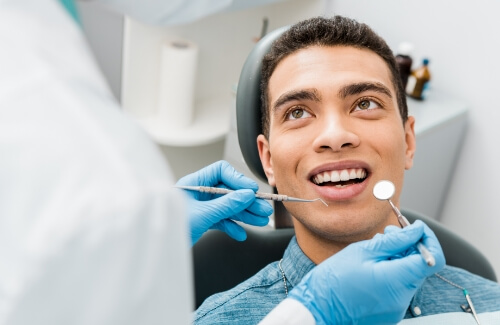 Man smiling at his dentist during a dental checkup