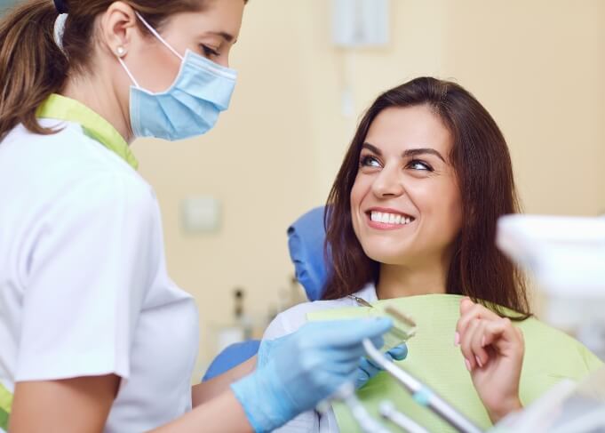 Woman smiling at her dentist during restorative dentistry visit