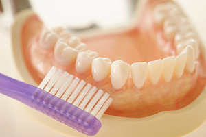 Close-up of toothbrush and dentures